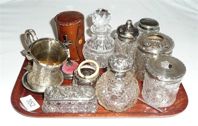 Lot 352 - Silver topped jars, silver christening mug, baby's rattle, silver hat pin stand, cased plated...