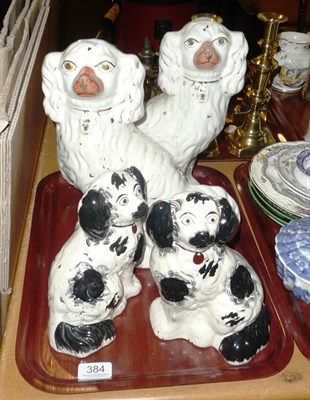 Lot 384 - A pair of late 19th century Staffordshire pottery spaniels, decorated and picked out in black and a