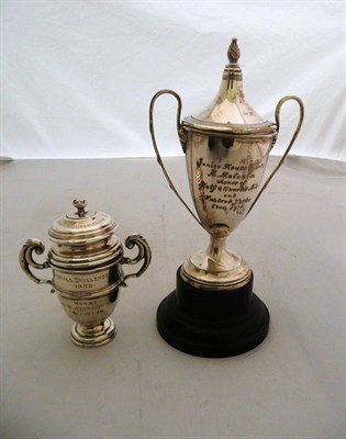 Lot 388 - A silver twin handled trophy cup and cover on base and another silver trophy cup and cover (2)