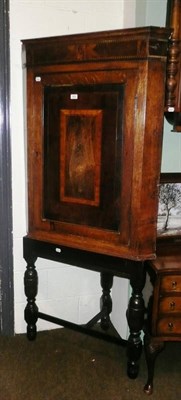 Lot 500 - Georgian mahogany cross-banded oak corner cupboard on later base