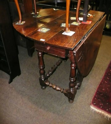 Lot 505 - A 19th century oak gateleg table with two drawers