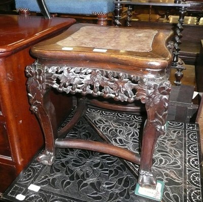 Lot 521 - A carved Eastern hardwood urn stand with marble inset top, two towel rails and an ebonised...