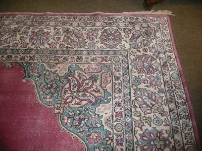 Lot 554 - A large Indian pink-ground carpet