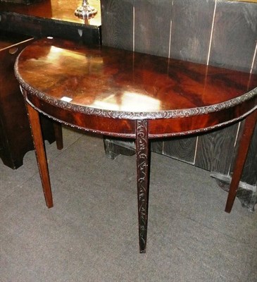 Lot 558 - A Chippendale-style mahogany demi-lune side table with Waring & Gillow label