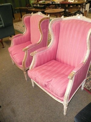 Lot 570 - A pair of French style elbow chairs with pink upholstery