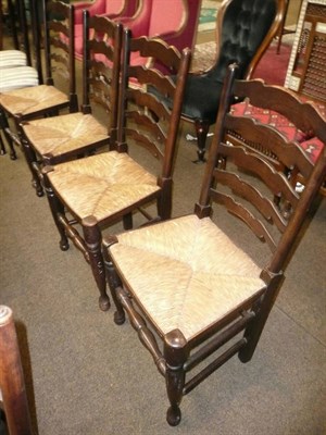 Lot 573 - A set of four ladder-back rush-seated chairs