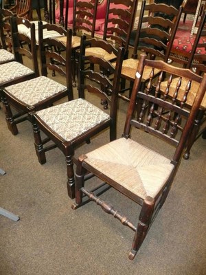 Lot 574 - Spindle back rush-seated rocking chair, a set of four ladder-back chairs, an oak ladder-back...