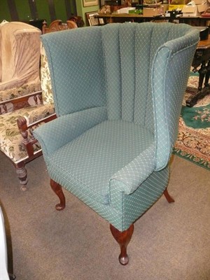 Lot 587 - An early 20th century upholstered wing armchair