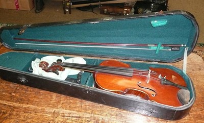 Lot 592 - A 19th century German violin with a bow in a stained pine coffin case