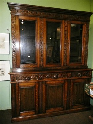 Lot 594 - Carved oak glazed bookcase