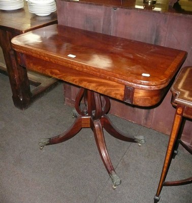 Lot 611 - A Regency cross-banded mahogany fold-over swivel-top card table