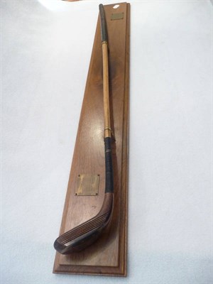 Lot 1030 - A Presentation Replica Long Nosed Scared Neck Putter, mounted on a mahogany board, with two...