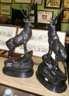 Lot 1055 - After Moigniez - A Pair of Modern Bronzed Metal Figures of Stags, each standing on an upswept rocky