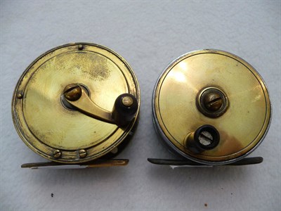 Lot 1159 - A 2 3/4inch Brass Crankwind Reel, with curved arm and black handle; A 2 1/2inch Brass Faced...