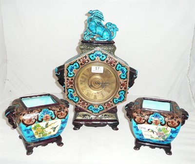 Lot 17 - A three piece pottery clock garniture with Fo dog finial, a.f.