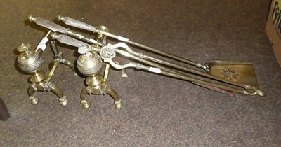 Lot 47 - A three piece brass companion set and a pair of brass fire dogs (5)