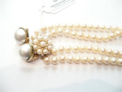 Lot 56 - Two row pearl necklace and a pair of mabe earclips