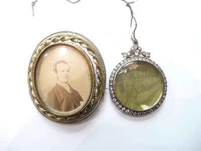 Lot 79 - A circular paste locket, stamped 925 with chain and a swivel centre locket brooch