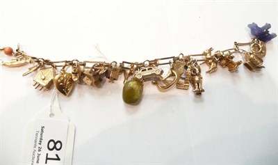 Lot 81 - A 9ct gold charm bracelet hung with twenty-two charms