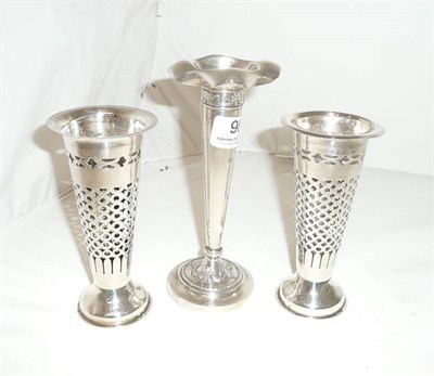 Lot 98 - A pair of pierced silver vases and another silver vase
