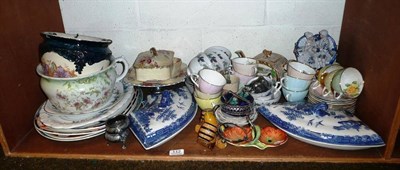 Lot 112 - Shelf of assorted ceramics including two blue and white curved shaped tureens with covers