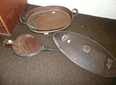 Lot 127 - A copper carriage warmer, an oval copper pan and an elm leather bellows