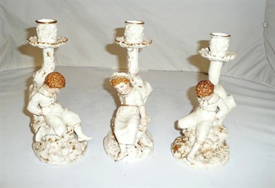 Lot 141 - Three Royal Worcester figural candlesticks