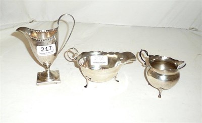 Lot 217 - A George III silver cream jug, silver sauce boat and a silver cream jug