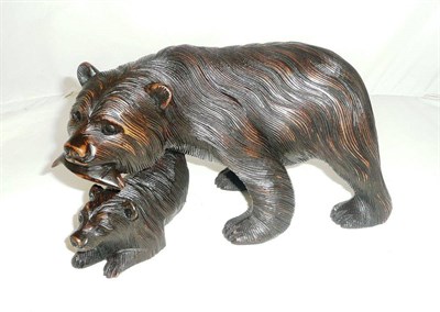 Lot 267 - Carved bear with salmon in mouth and young