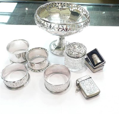 Lot 332 - A silver bonbon dish, four napkin rings, a glass silver top bottle, a vesta, a thimble