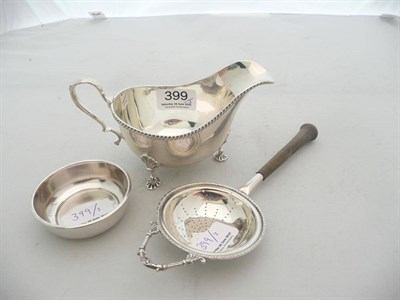 Lot 399 - Silver gravy boat and silver tea strainer and stand