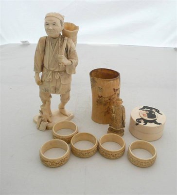 Lot 405 - A Japanese ivory figure a/f, a small tusk vase, five napkin rings, a monkey box and cover, a...