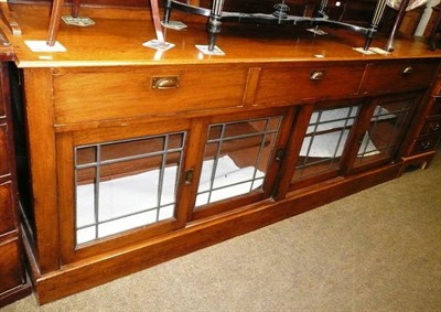 Lot 547 - Oak shop counter with sliding leaded glazed doors