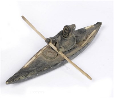 Lot 1180 - A Canadian Inuit Carved Green Soapstone and Bone Mounted Model of a Hunter in a Kayak, 20th...