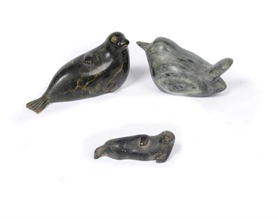 Lot 1181 - A Canadian Inuit Carved Green Soapstone Female Walrus and Pup, 20th century, each in recumbent...