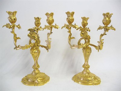 Lot 1194 - A Pair of French Ormolu Rococo Revival Three-Light Table Candelabra, 19th century, with...