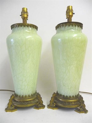 Lot 1196 - A Pair of French Green Marbled Glass Table Lamp Bases, late 19th century, of shouldered...