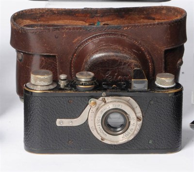 Lot 1117 - A Leica I(A) Camera No.30764, circa 1930, with black enamelled body, hockey stick lens lock,...