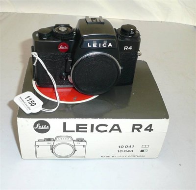 Lot 1150 - A Leica R4 Camera Body No.1571705, in black, with passport, manual, plastic box and cardboard...
