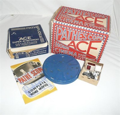 Lot 1174 - A Boxed Pathescope 'Ace'' 9.5mm Film Projector,  with accessories and eleven boxed films, including
