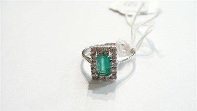 Lot 59 - A 14ct white gold emerald and diamond cluster ring