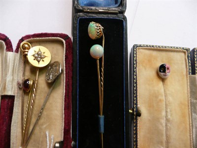 Lot 72 - Two opal tie pins, a mask pin, an Art Nouveau pin and three others