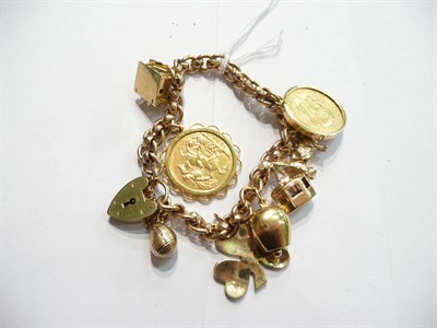 Lot 91 - A charm bracelet hung with six charms and a 1913 sovereign and a 1905 sovereign