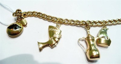 Lot 92 - A charm bracelet hung with three charms and one loose, stamped '750'