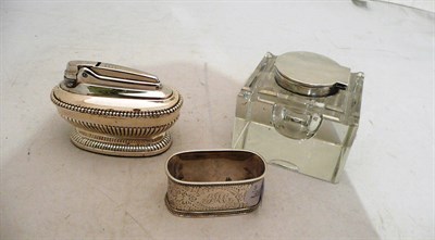 Lot 114 - A silver-mounted glass inkwell, a Victorian napkin ring and a Ronson lighter (3)