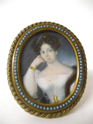 Lot 1292 - German School, initialed DF: Portrait Miniature of a Young Woman, circa 1840-50, her curly...