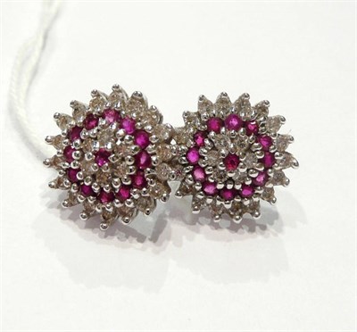 Lot 196 - A pair of ruby and diamond cluster stud earrings