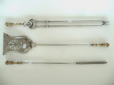 Lot 1297 - A Set of Three Brass Mounted Steel Fire Irons, 19th century, each with scroll and fruit swag...