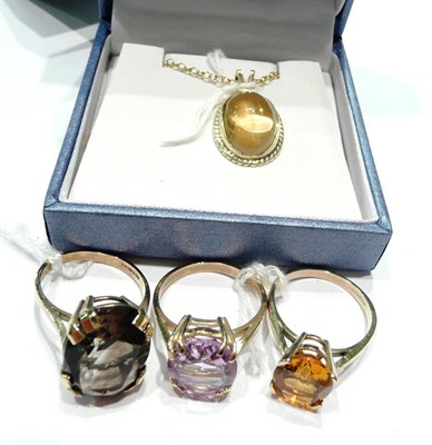 Lot 204 - An amethyst ring, a citrine ring, a smokey quartz ring and a 9ct gold pendant on chain