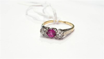 Lot 212 - A diamond and red stone three stone ring